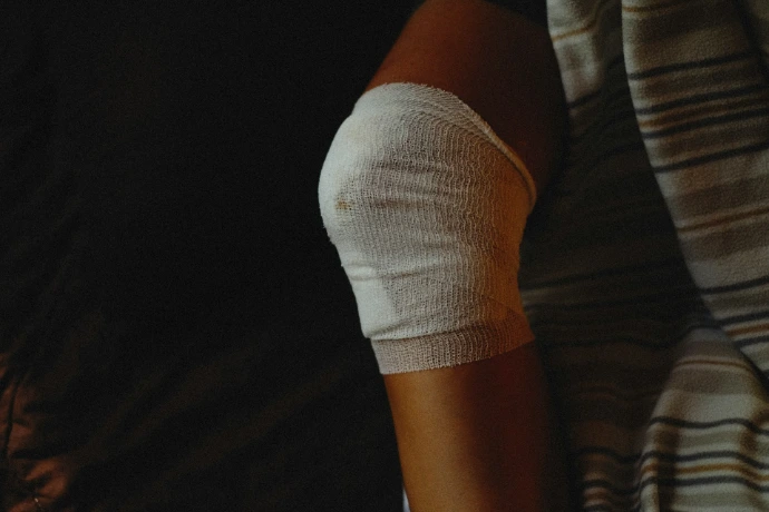 a person wearing a bandage over a wound