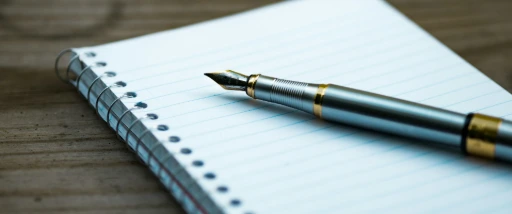 fountain pen on spiral book