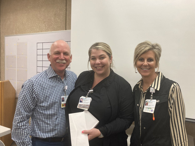 White Rock Interim CEO Jim Parobek (left) and Melanie Flinn, vice president for operations (right), recognized Brittany H. (center) as Employee of the Month for March.